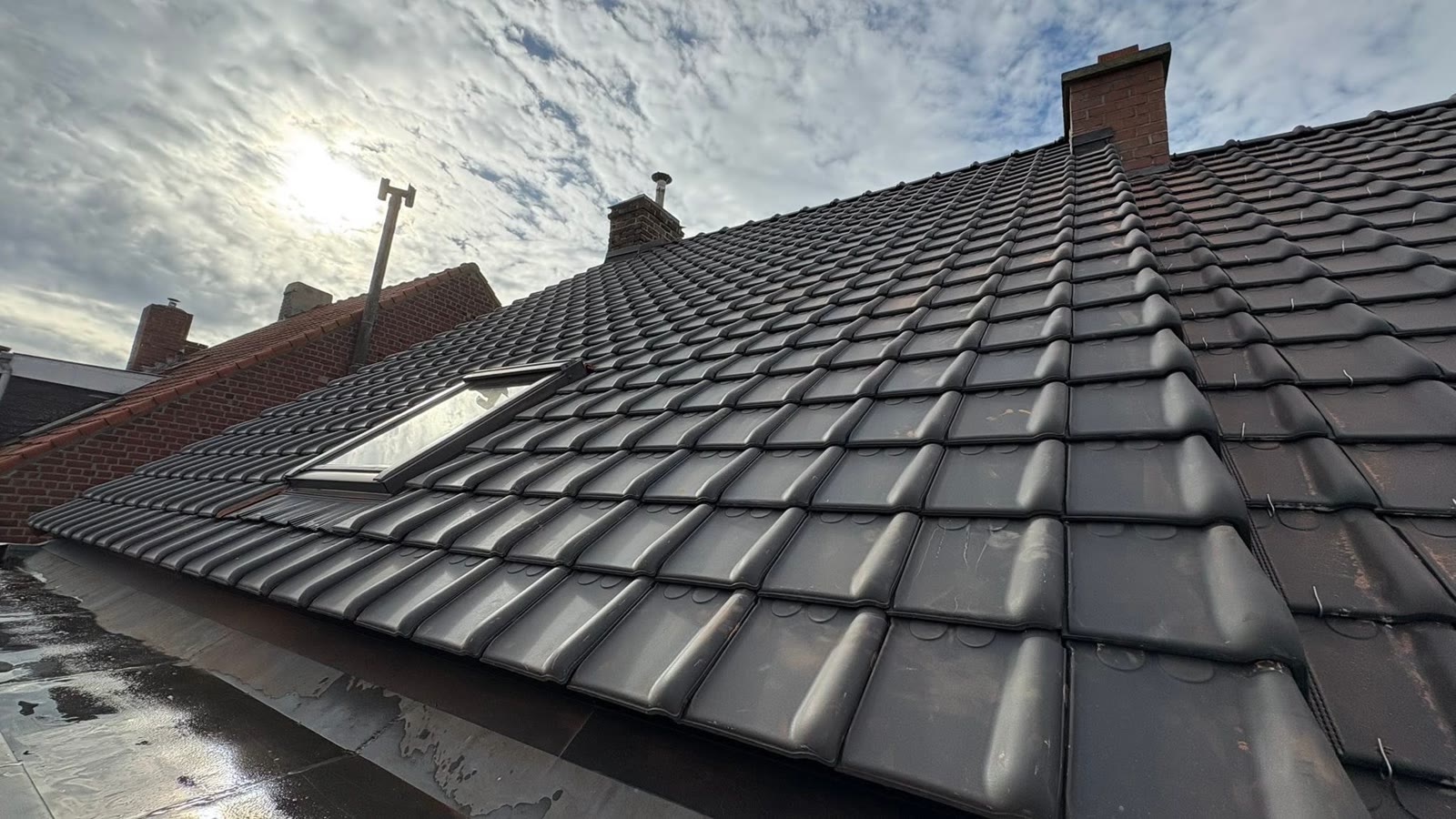 Toiture en tuiles anthracite avec fenêtre de toit